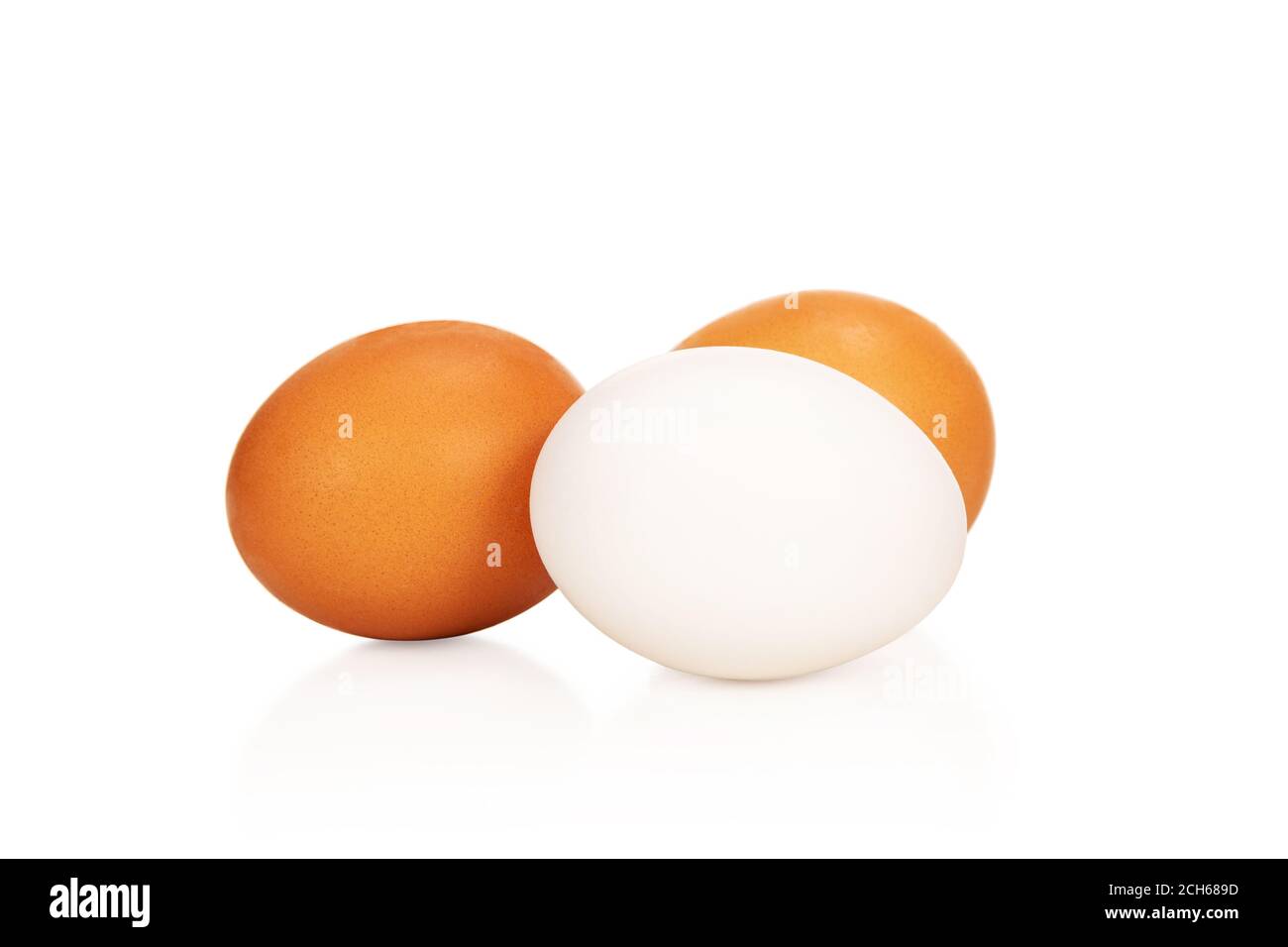Three eggs - one white and two brown, lying next to each other isolated on white fonena white Stock Photo