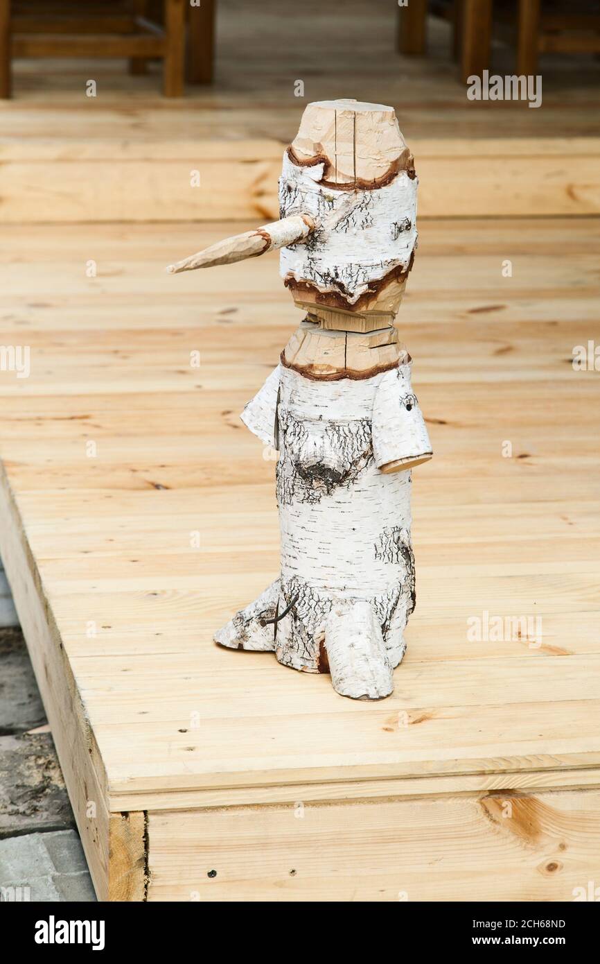 Pinocchio Log Pinocchio figure made from a whole wooden log with selective focus ...