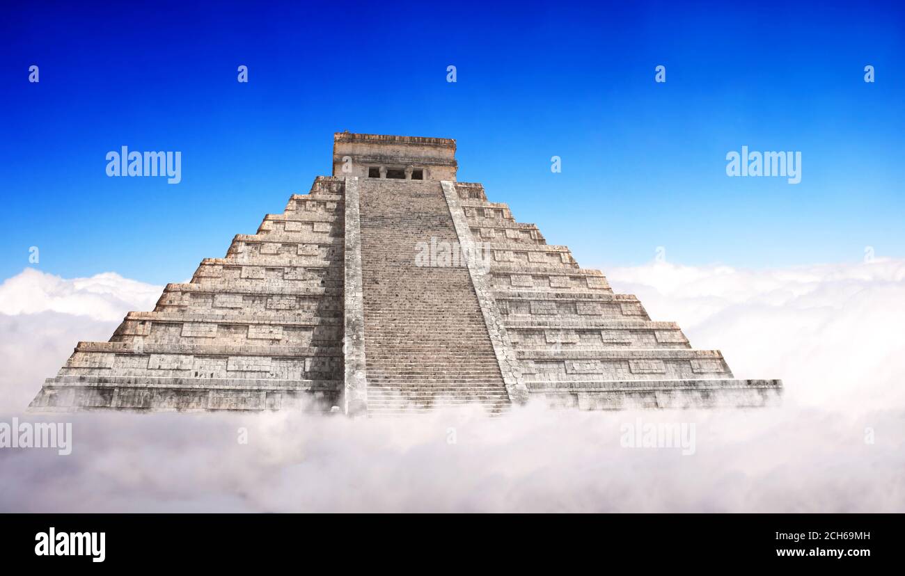 Giant Mayan Pyramid with a base hidden in the clouds. Horizontal banner with ancient pyramid of maya (Kukulcan Temple), Chichen Itza, Yucatan, Mexico. Stock Photo