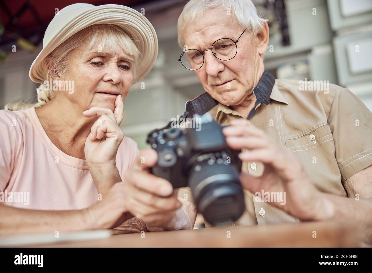 Puzzled aged people staring into the digital camera Stock Photo
