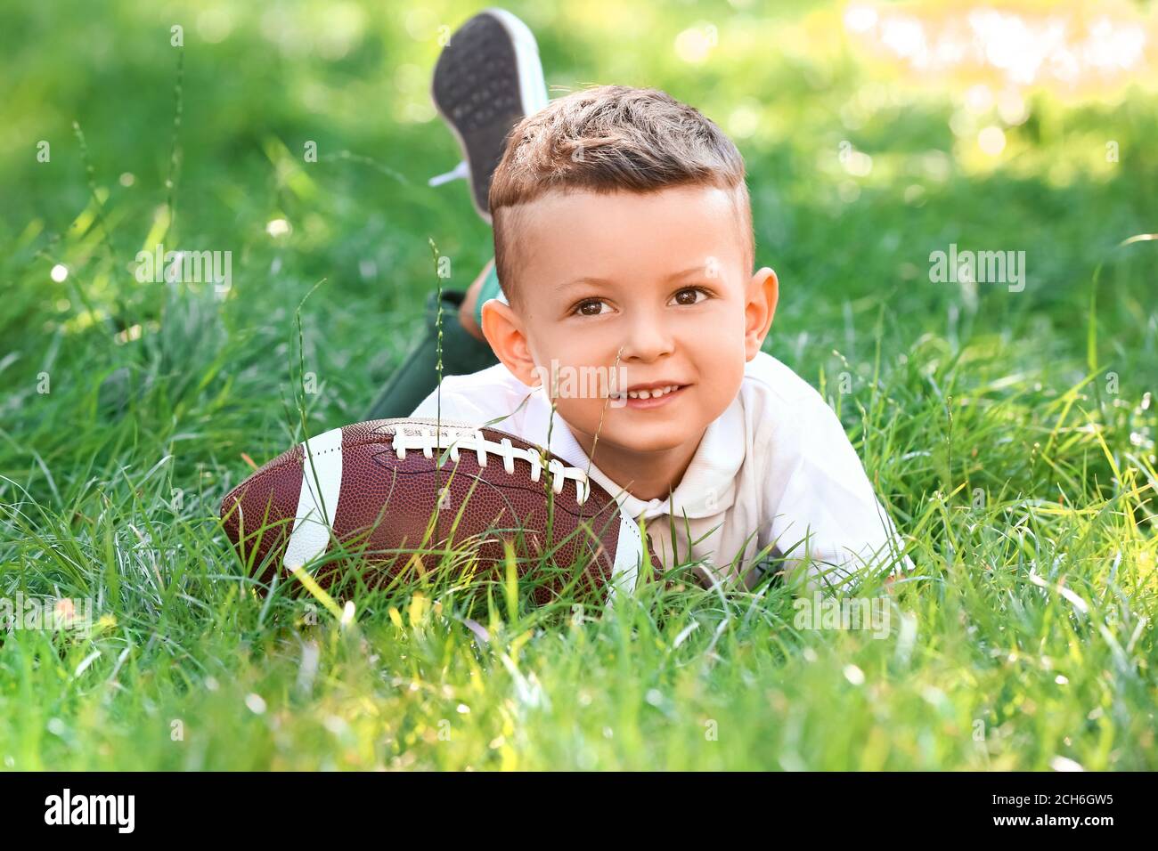 Little boy with rugby ball outdoors Stock Photo Alamy