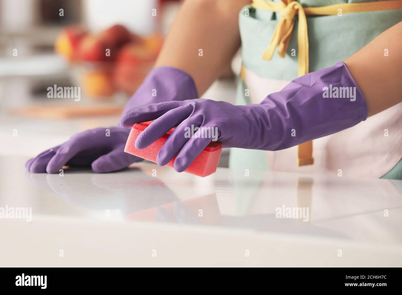 Woman in rubber gloves cleaning kitchen Stock Photo - Alamy