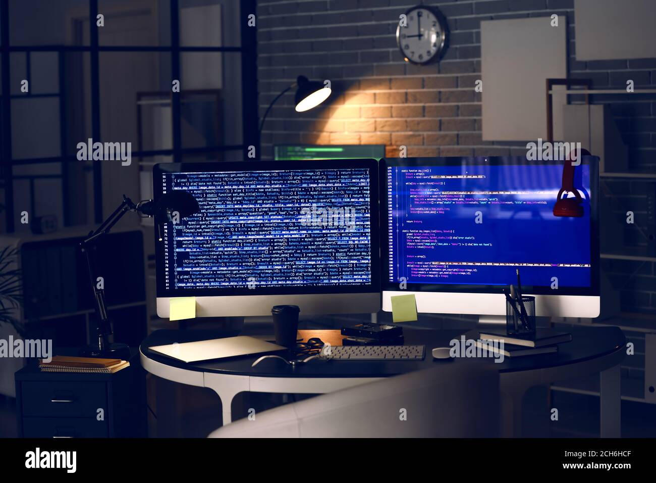 Workplace of programmer in office at night Stock Photo - Alamy