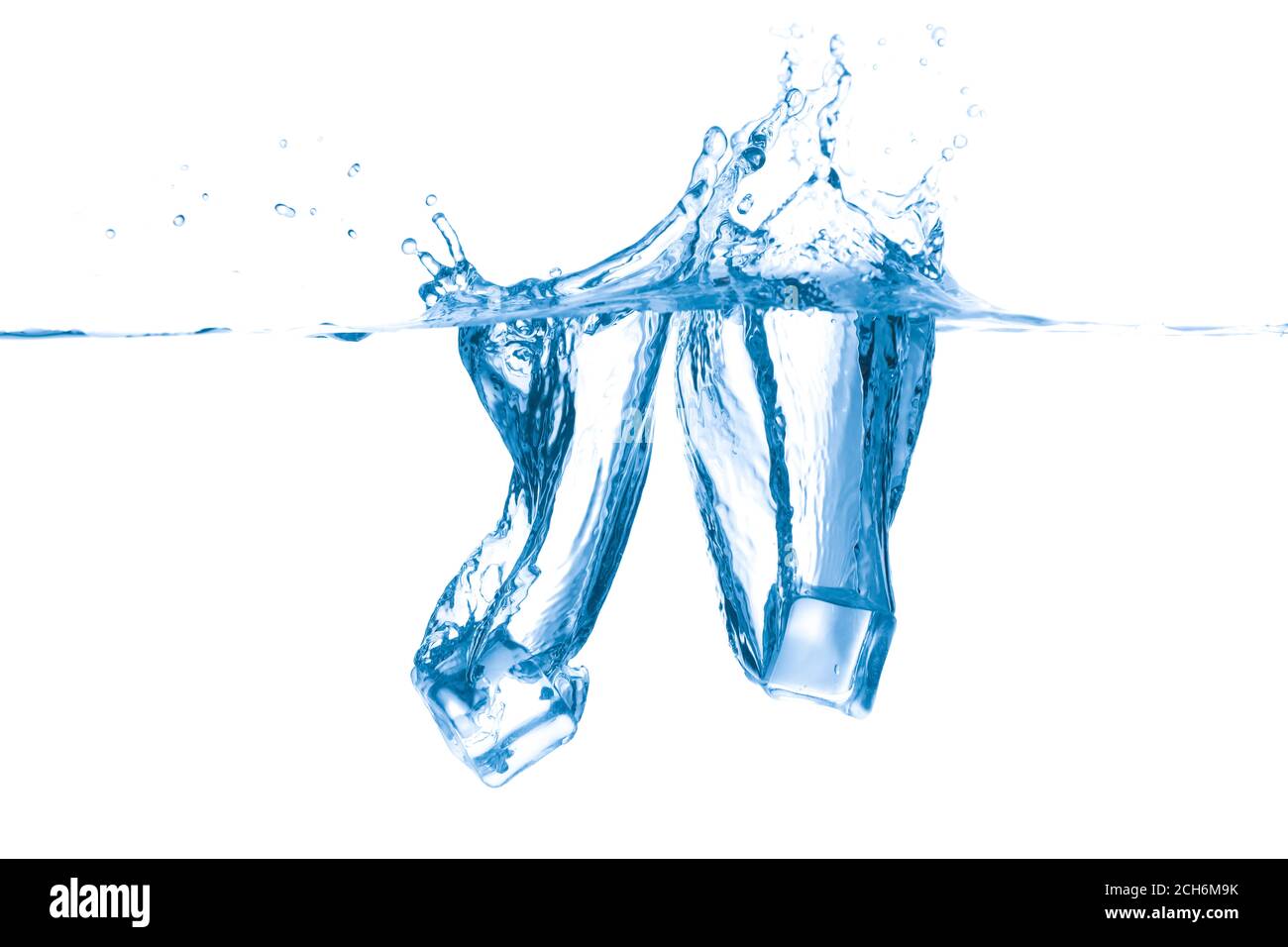 Falling of ice cubes into water on white background Stock Photo - Alamy