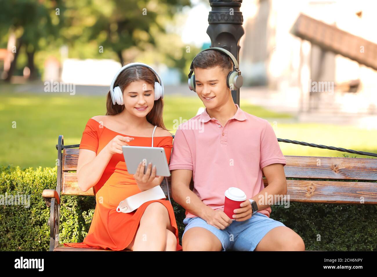 Teen friends listening music park hi-res stock photography and images ...