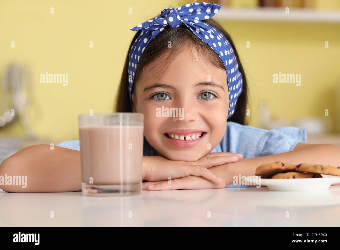 Little girl drinking tasty chocolate milk at home Stock Photo Alamy