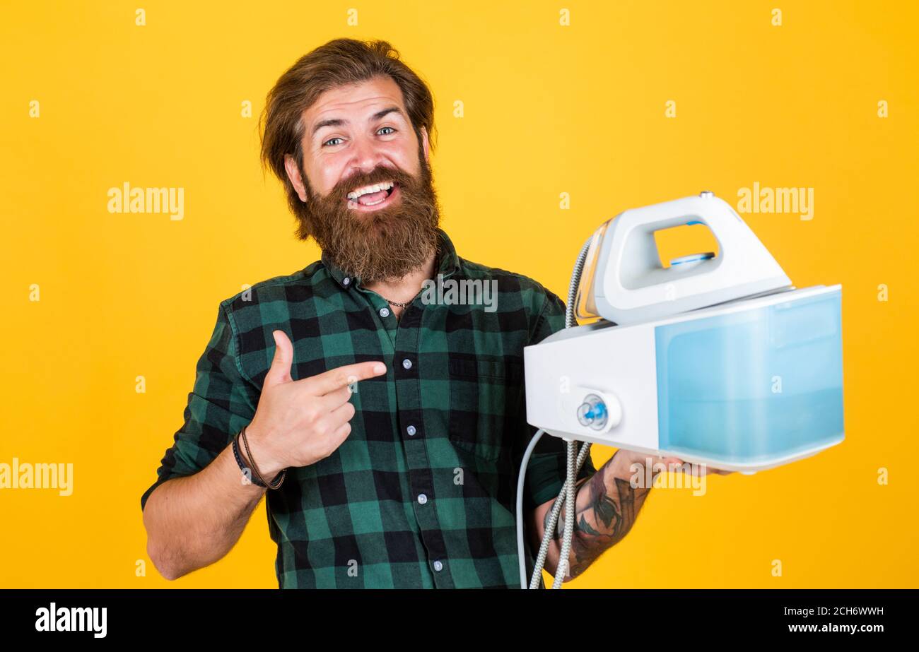 You cant live without it. Man at home ironing clothes. happy house