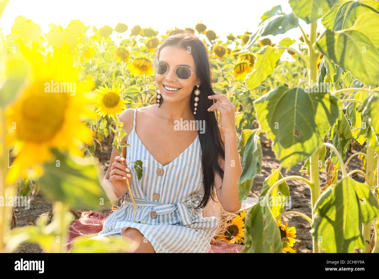 Beautiful young woman in sunflower field Stock Photo - Alamy