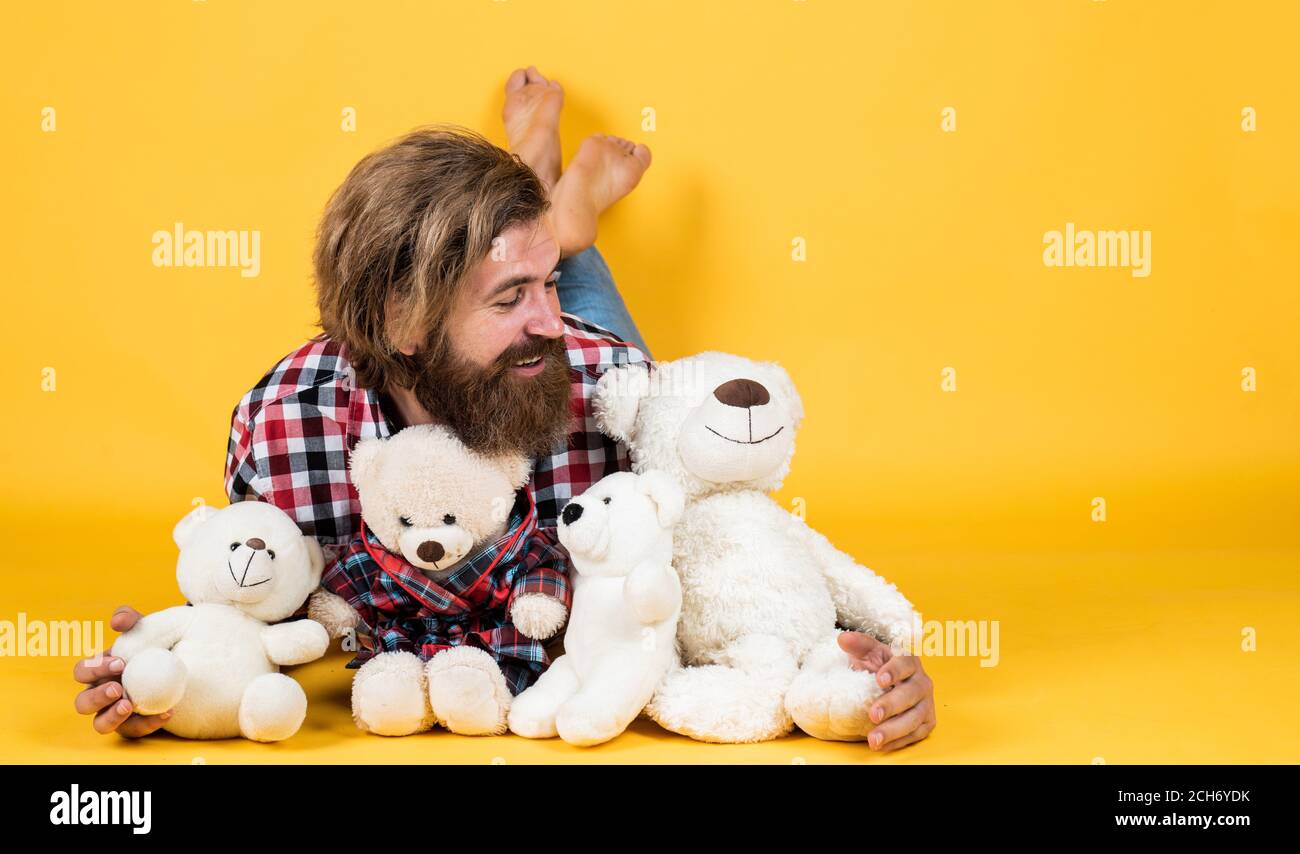 being in good mood. happy valentines day. cheerful bearded man hold teddy bear. male feel playful with bear. brutal mature hipster man play with toy. happy birthday. copy space. Stock Photo