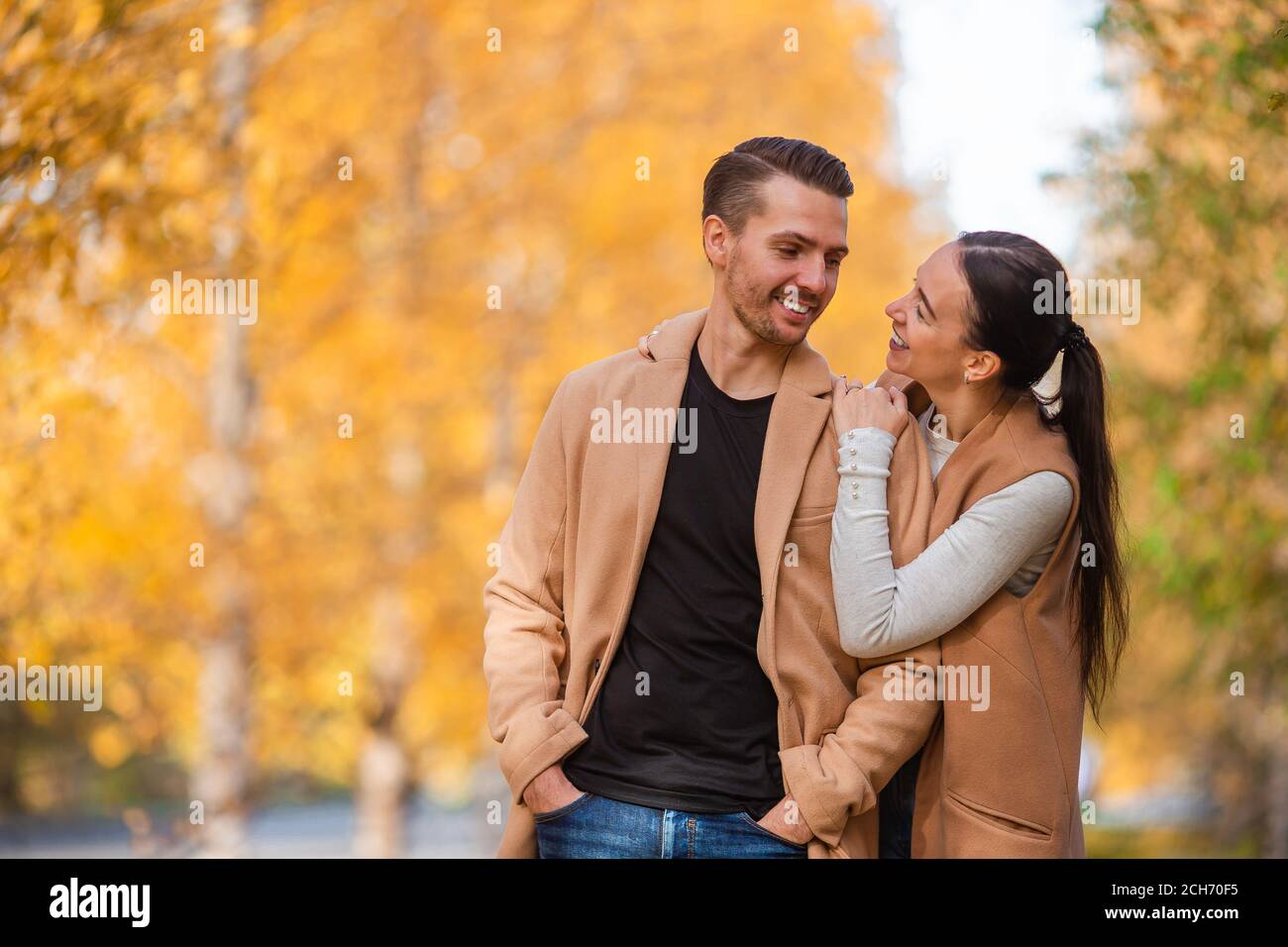Happy family walking in autumn park on sunny fall day Stock Photo - Alamy