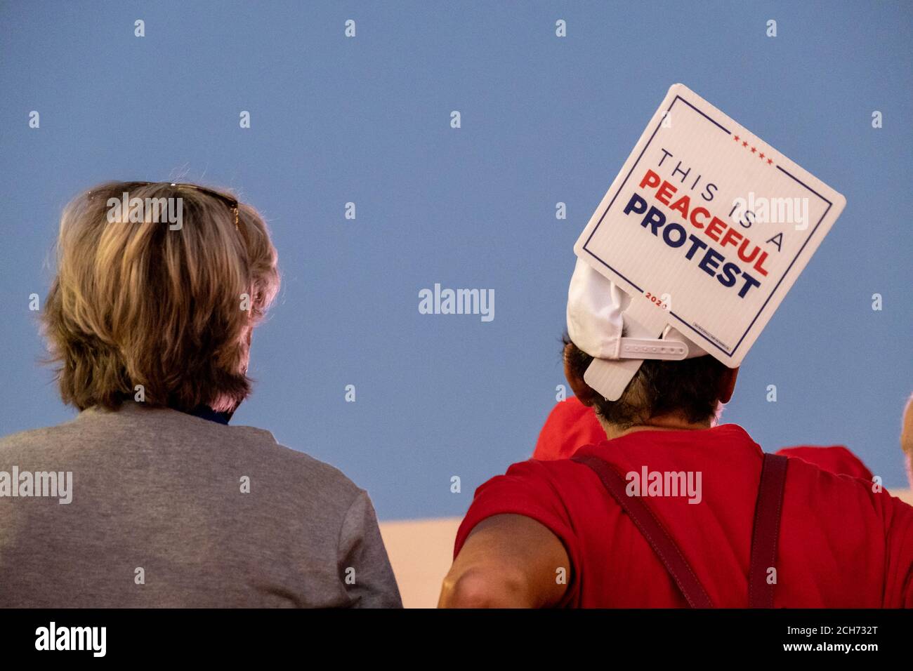 Henderson, NV, USA. 13th Sep, 2020. A woman displays a 'This is a peaceful protest' sign outside Xtreme Manufacturing, the venue for a packed Trump campaign event.The venue was filled to capacity and much of the crowd had overflowed outside onto the street. Credit: Young G. Kim/Alamy Live News Stock Photo