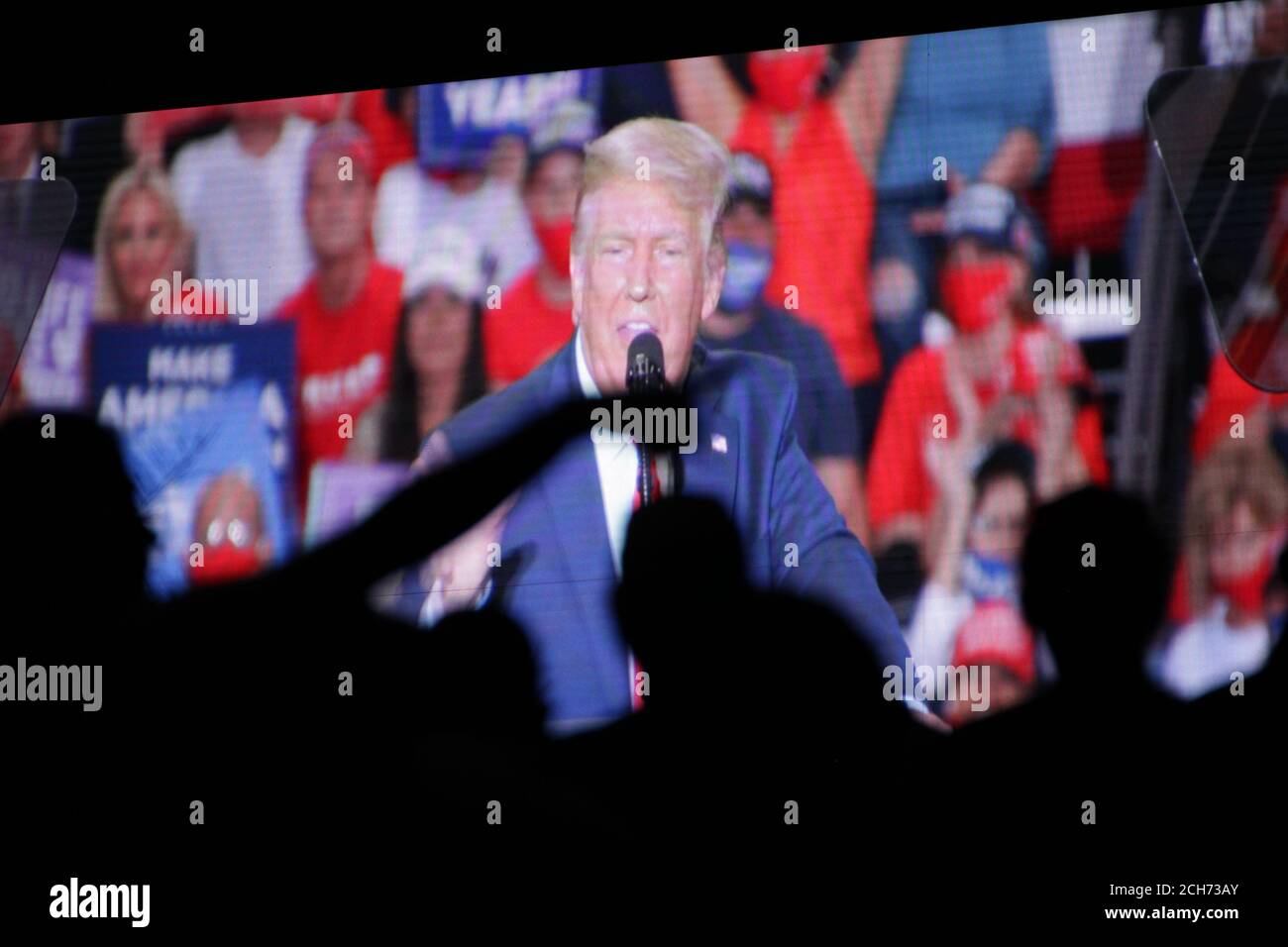 Henderson, NV, USA. 13th Sep, 2020. Supporters of President Donald Trump gather outside Xtreme Manufacturing to watch him on a big screen as he gives a speech. The venue was filled to capacity and much of the crowd had overflowed outside onto the street. Credit: Young G. Kim/Alamy Live News Stock Photo