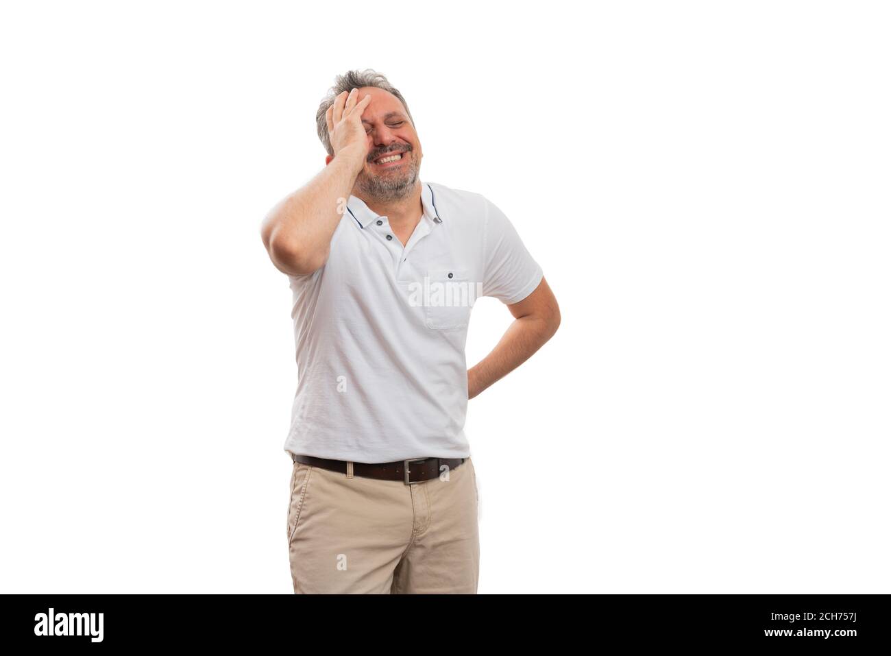 Man wearing white tshirt laughing smiling touching forehead as funny gesture fashionable stylish casual summer clothing concept isolated on studio bac Stock Photo