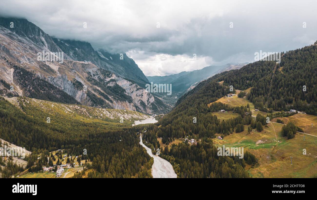 Panorama of a Alpine mountain valley and peaks. High mountain peaks and a glacier and water falls on the Italian side of the Mont Blanc Massive. Stock Photo