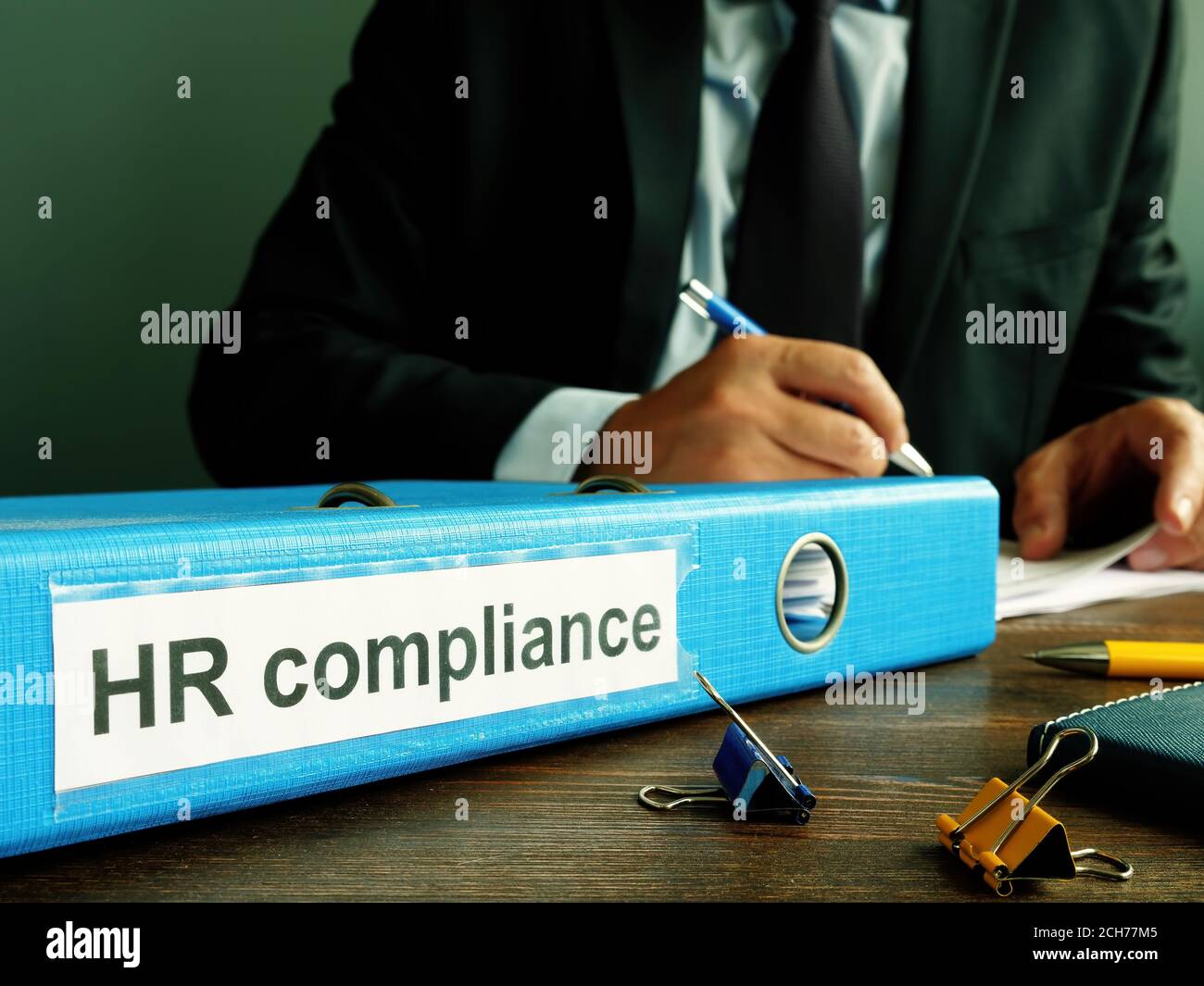 Folder with HR compliance papers and manager. Stock Photo