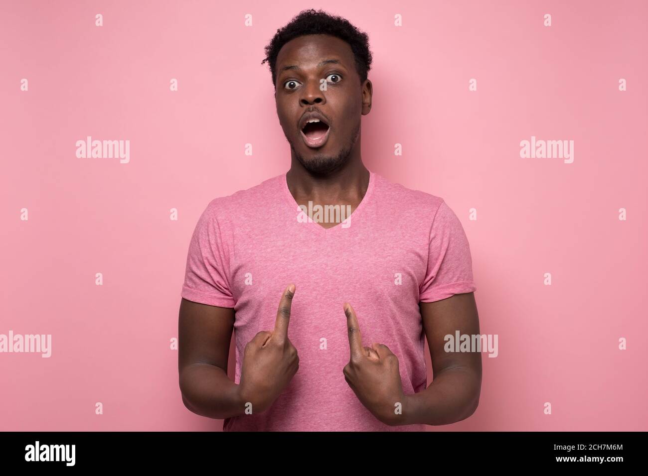 man looking at camera pointing at himself with hands being surprised Stock Photo