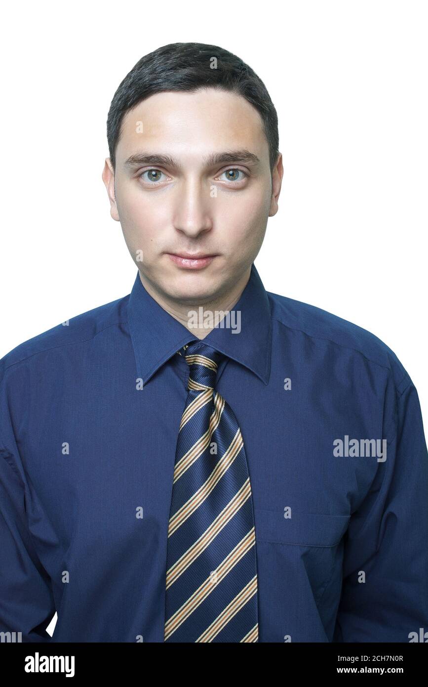 Serious young man in dark blue shirt and tie isolated on white