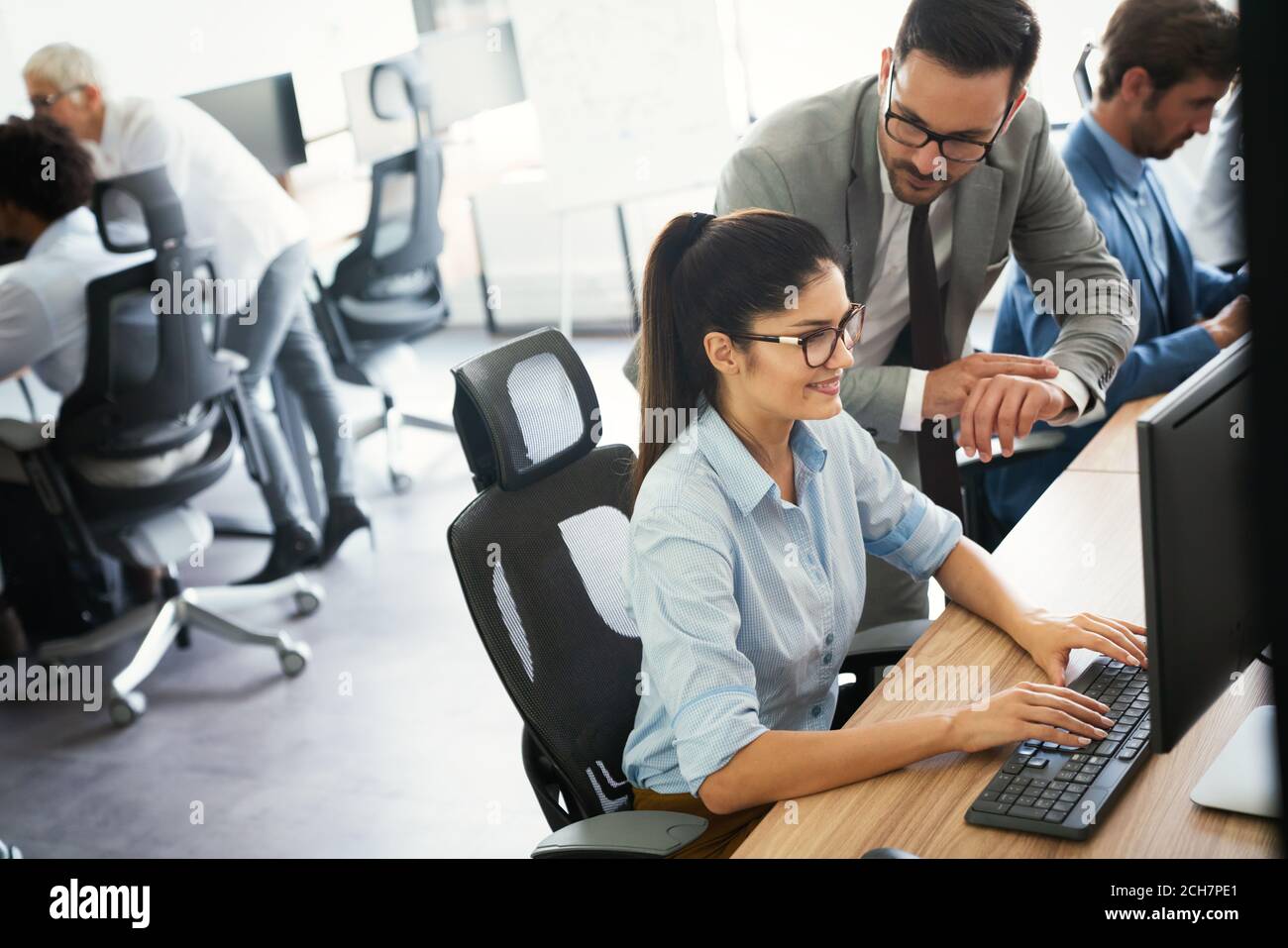 Programmers cooperating at IT company developing apps Stock Photo