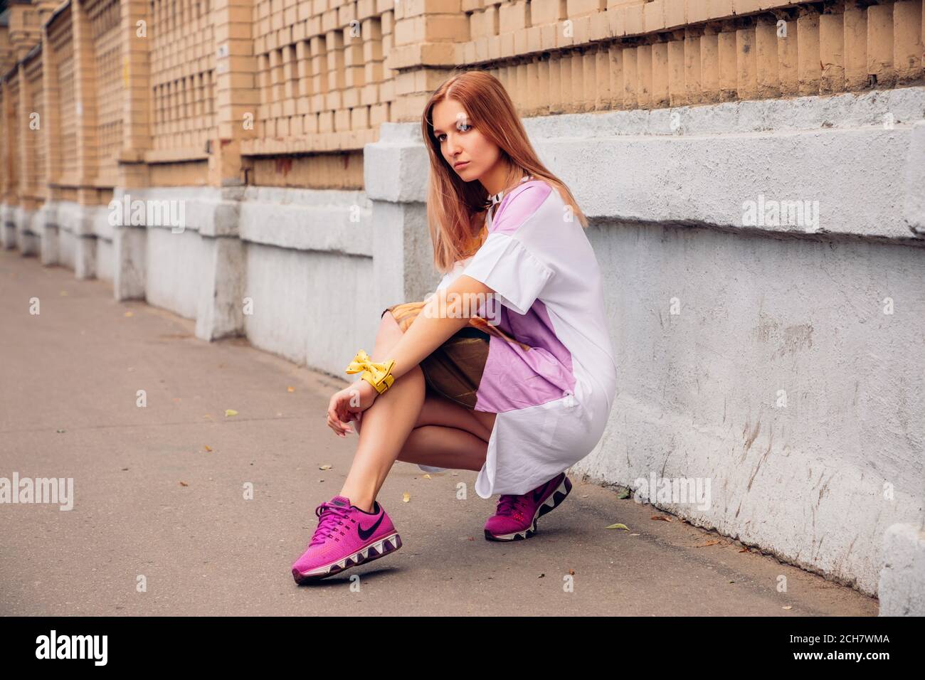 Pretty blonde girl in sneakers hi-res stock photography and images - Alamy