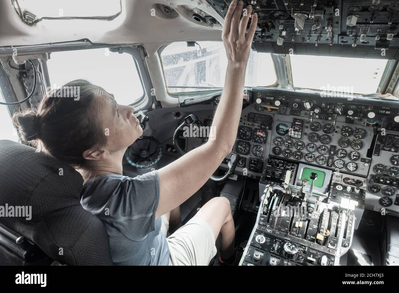 Woman in cockpit of airplane in science museum. Stock Photo