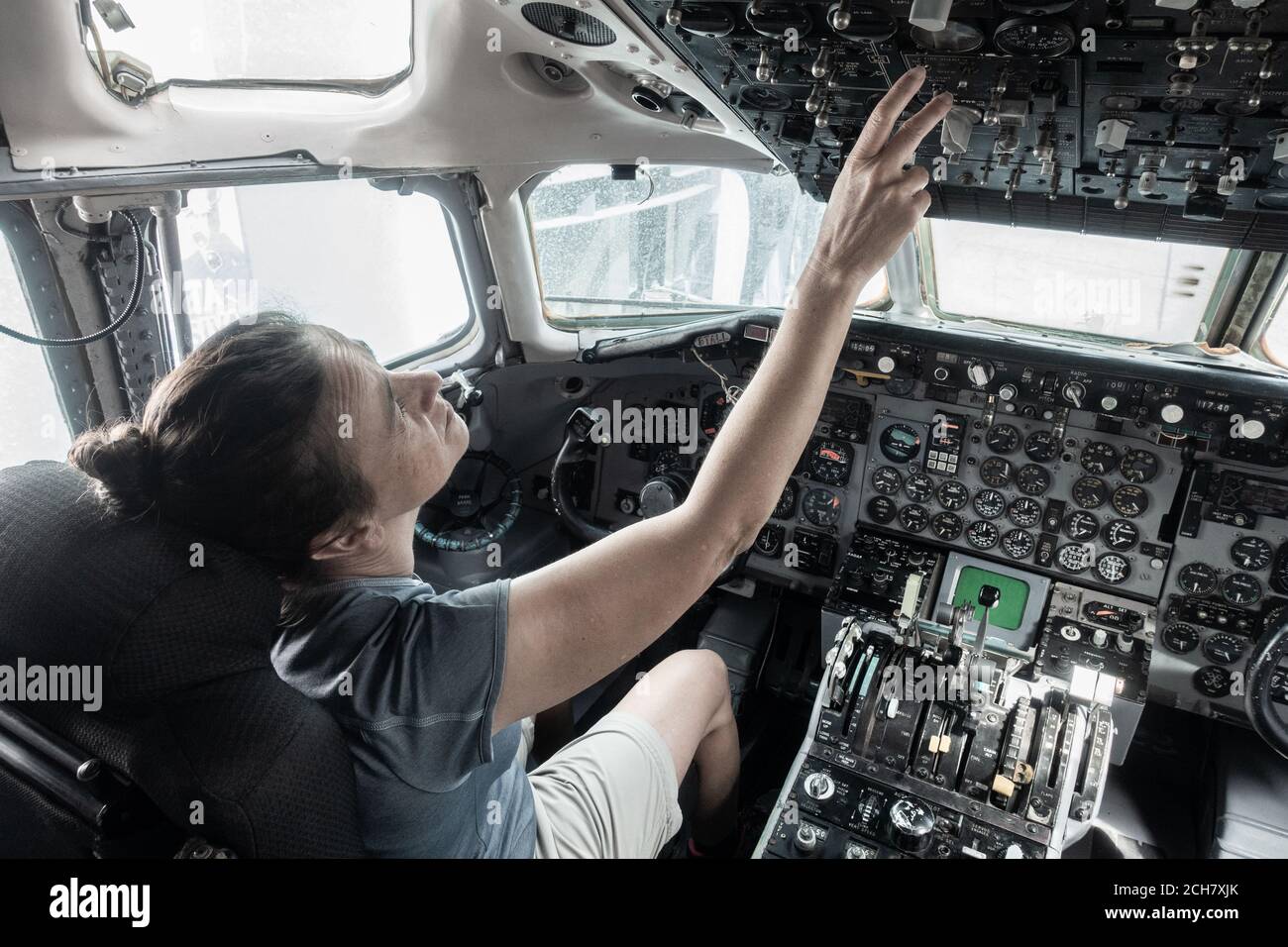 Woman in cockpit of airplane in science museum. Stock Photo