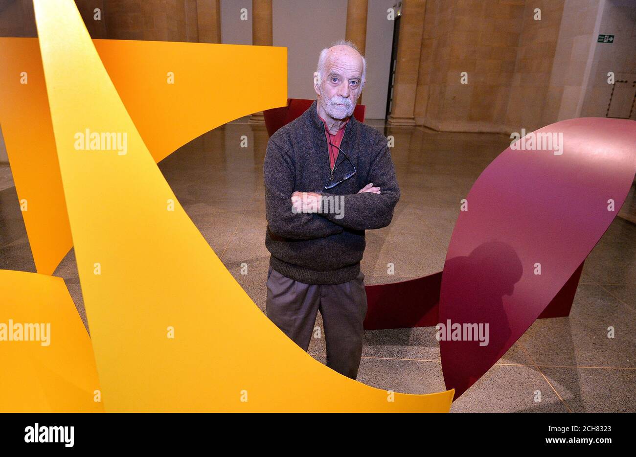 Phillip King stands inside his sculpture 'Dunstable Reel', 1970, as an exhibition of a selection of his work goes on display to celebrate his 80th birthday, at the Tate Britain Gallery in London. Stock Photo