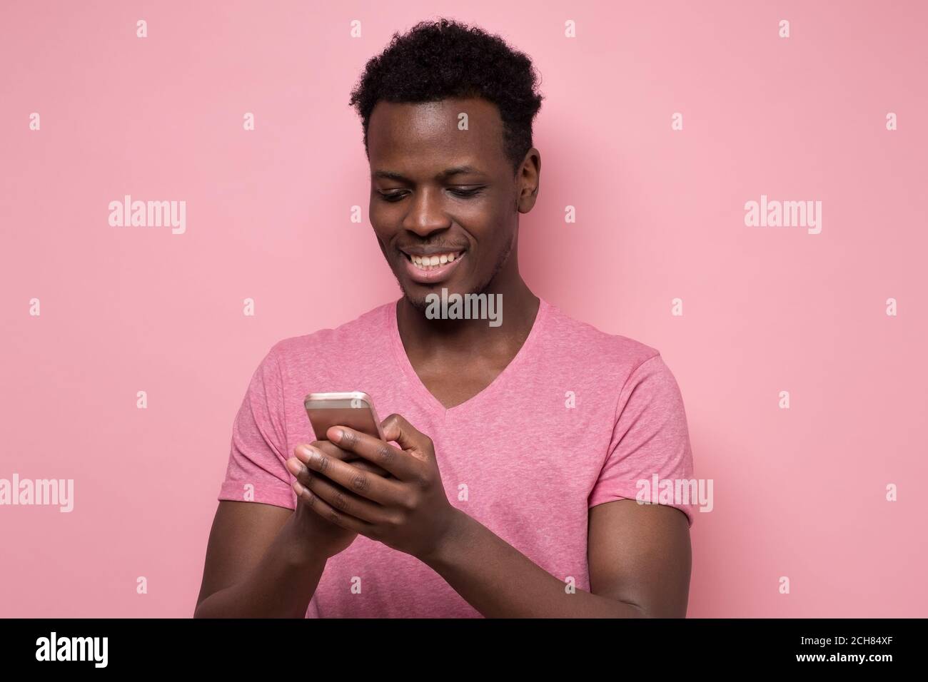 Young african man reading sms on the phone Stock Photo