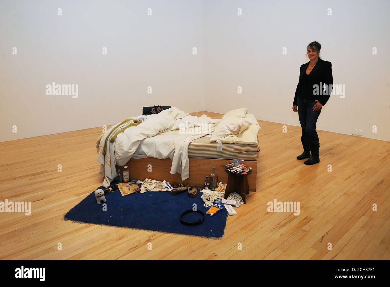 Tracey Emin stands alongside her installation entitled 'My Bed', as it returns to Tate Britain for the first time in 15 years. Stock Photo