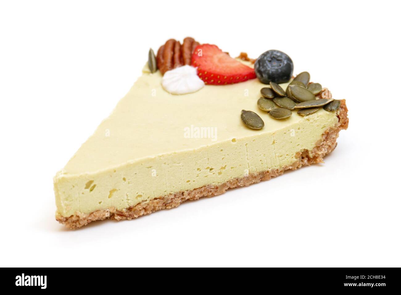 Vegan lemon avocado pie isolated on white background, side view, ingredients listed in keywords Stock Photo
