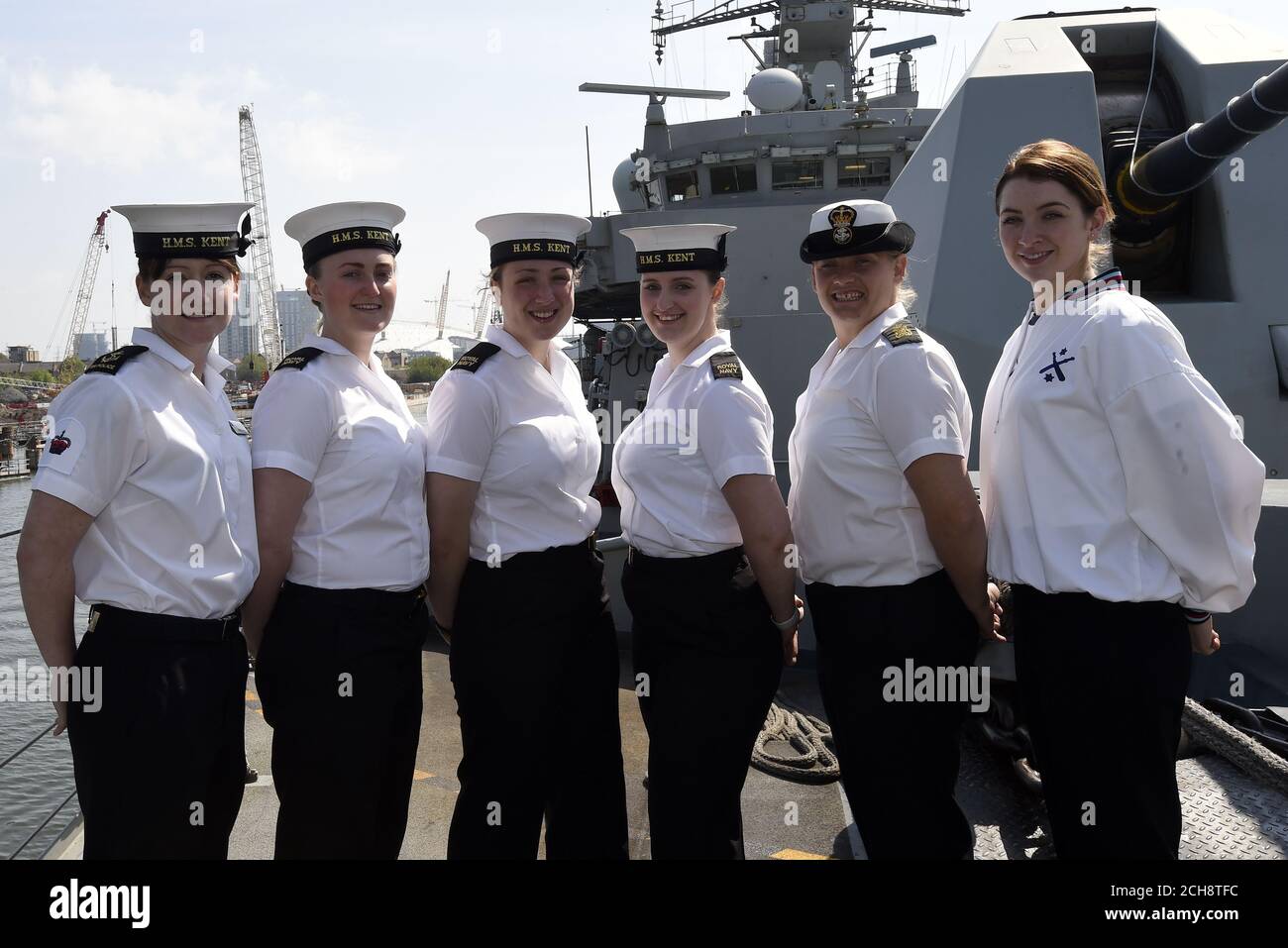 (left to right) Leading Regulator Nichola Connolly, 26, Engineering Technicians' (Communications and Information Systems Specialists') Emily Bunting, 24 and Olivia Morris, 19, Steward Hannah Watson, 23, Petty Officer (Weapon Engineering) Sarah Jenkins and Leading Physical Trainer Charlotte Mason, 22, who form part of the 22 women out of a core Ship's Company of 165 on board HMS Kent as she docks at West Quay Dock in Canary Wharf, London on her way to Scotland to take part in the Battle of Jutland centenary commemorations. Stock Photo