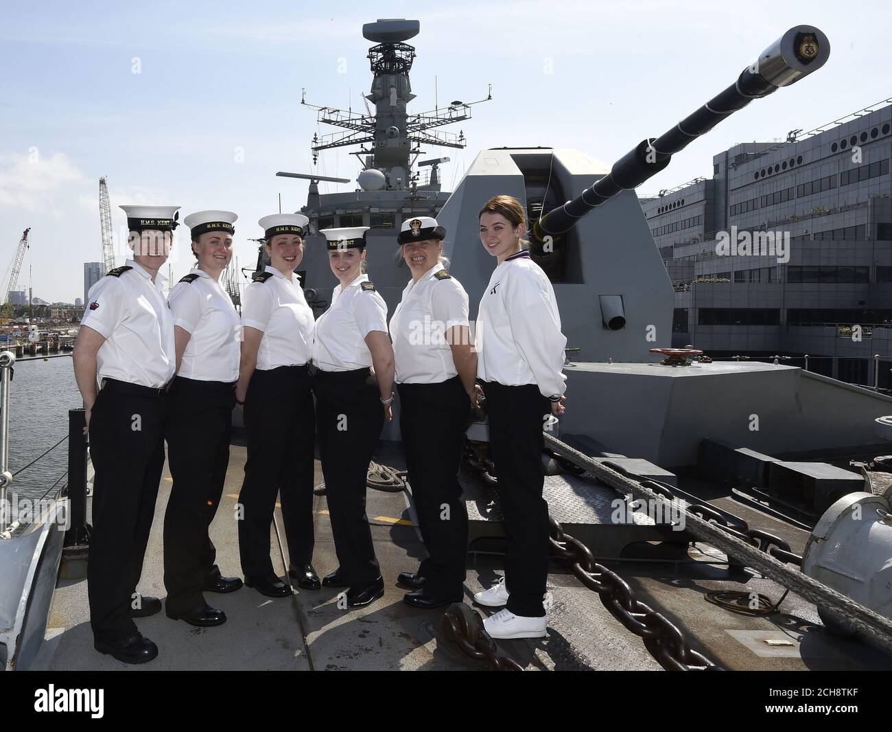 (left to right) Leading Regulator Nichola Connolly, 26, Engineering Technicians' (Communications and Information Systems Specialists') Emily Bunting, 24 and Olivia Morris, 19, Steward Hannah Watson, 23, Petty Officer (Weapon Engineering) Sarah Jenkins and Leading Physical Trainer Charlotte Mason, 22, who form part of the 22 women out of a core Ship's Company of 165 on board HMS Kent as she docks at West Quay Dock in Canary Wharf, London on her way to Scotland to take part in the Battle of Jutland centenary commemorations. Stock Photo