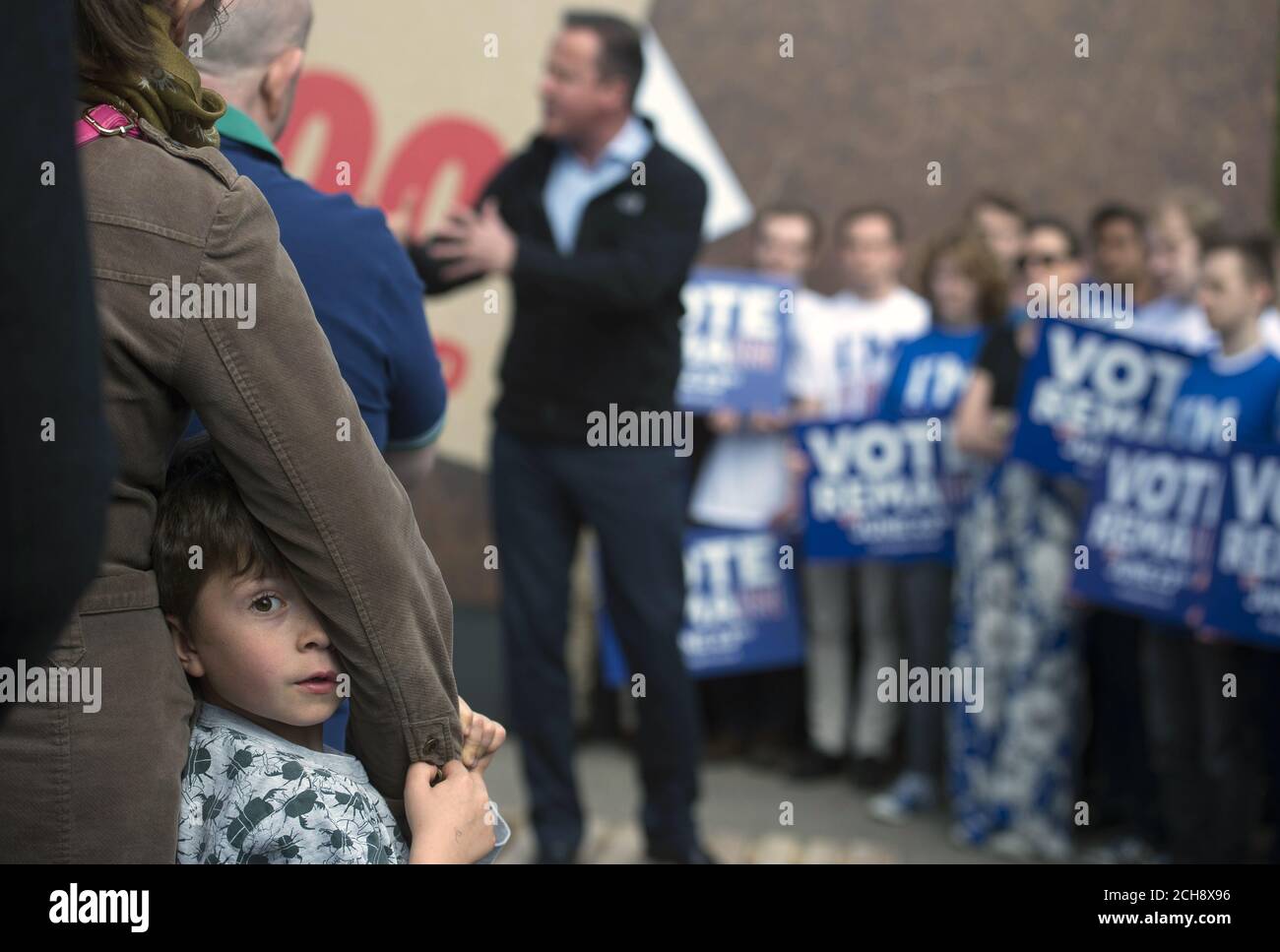 A child looks around as Prime Minister David Cameron delivers a speech at a Remain campaign event in his Witney constituency in Oxfordshire, where he warned that a vote to leave the European Union could tip the British economy back into recession. Stock Photo