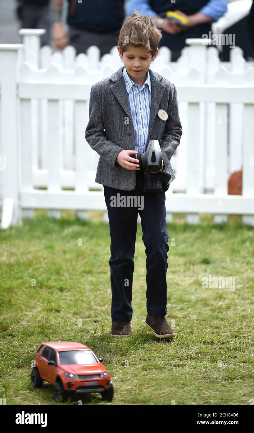 James, Viscount Severn drives a remote control Land Rover car, as he(00)