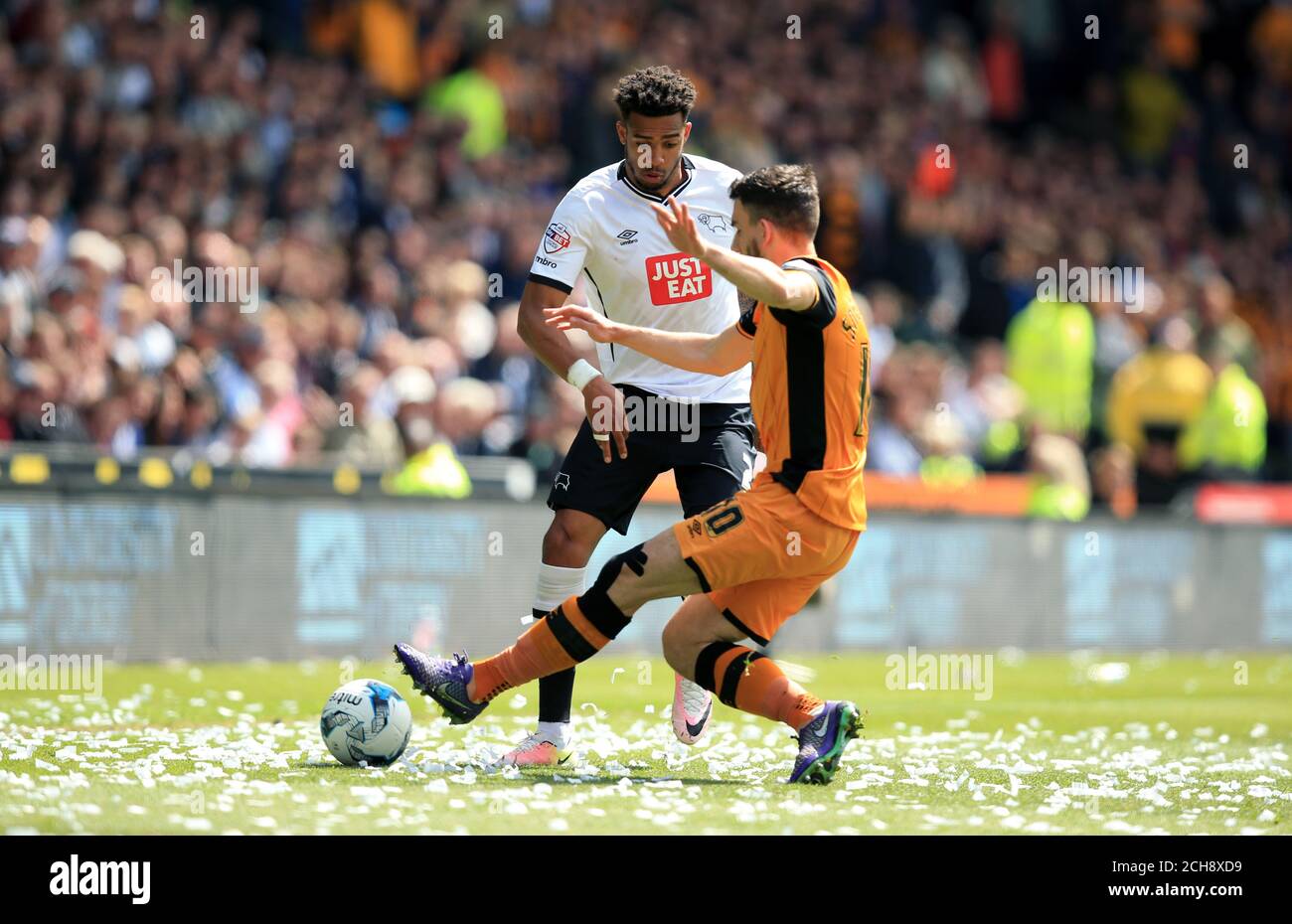 Derby County's Cyrus Christie and Hull City's Robert Snodgrass (right) battle for the ball during the Sky Bet Championship playoff, first leg match at the iPro Stadium, Derby. Stock Photo