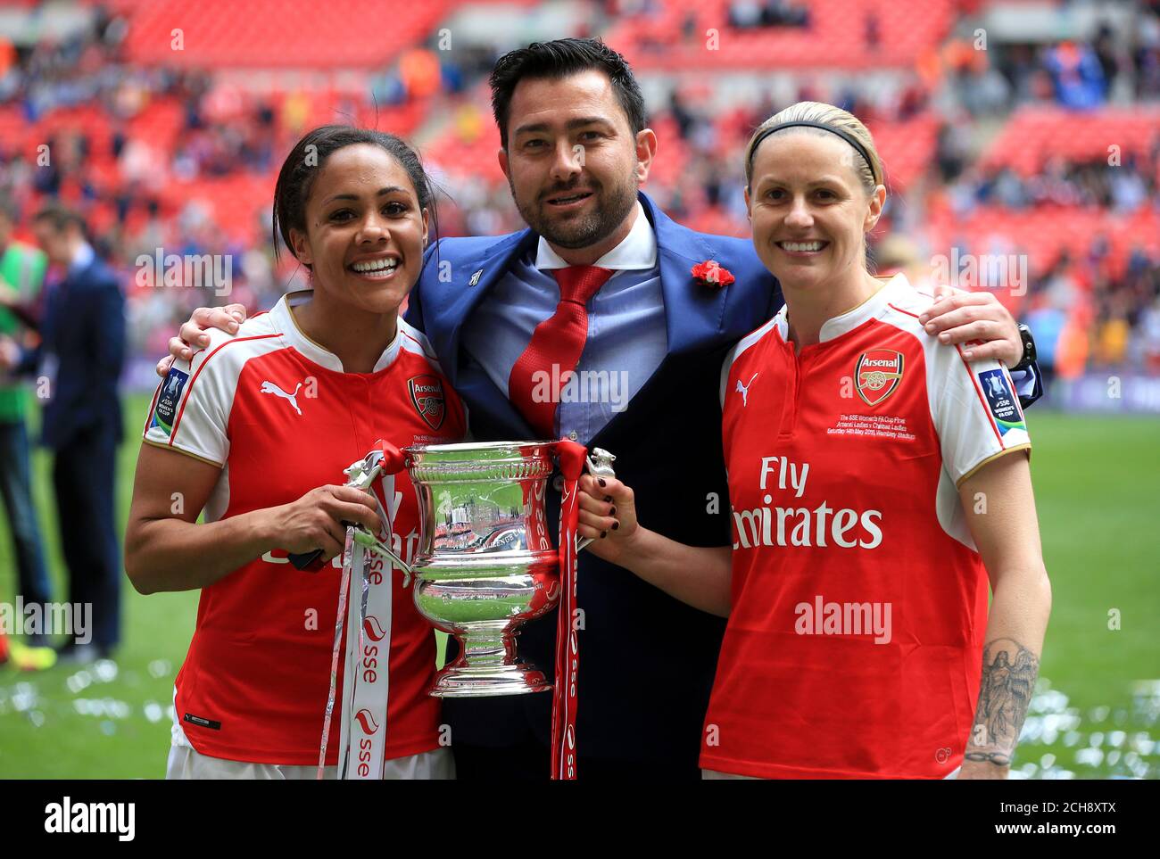Arsenal's Alex Scott (left), manager Pedro Martinez Losa and Kelly Smith hold the trophy and celebrate their victory after winning the SSE Women's FA Cup Final at Wembley Stadium, London. Stock Photo