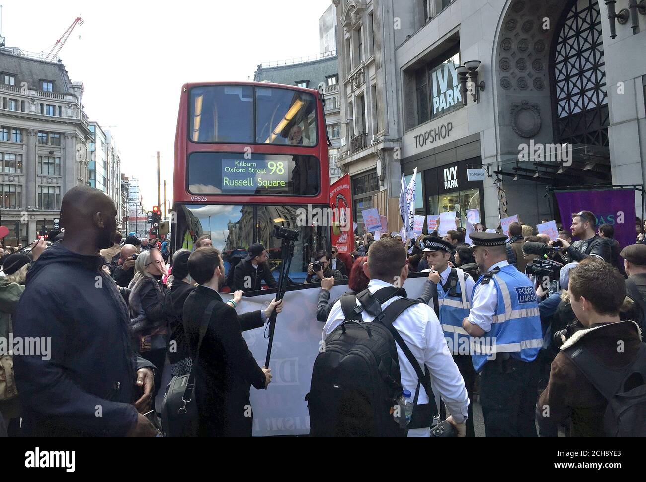 Protesters block traffic outside Topshop in Oxford street, London in a demonstration against Topshop owner Sir Philip Green. Stock Photo