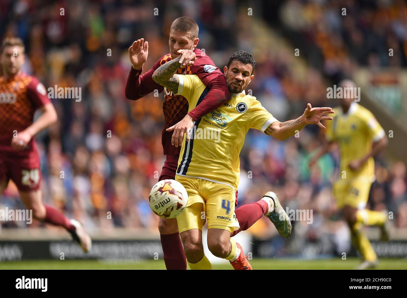 Bradford City's Jamie Proctor (left) and Milwall's Carlos Edwards battle for the ball during the Sky Bet League One play off, first leg match at Valley Parade, Bradford. PRESS ASSOCIATION Photo. Picture date: Sunday May 15, 2016. See PA story SOCCER Bradford. Photo credit should read: Jon Buckle/PA Wire. RESTRICTIONS: EDITORIAL USE ONLY No use with unauthorised audio, video, data, fixture lists, club/league logos or 'live' services. Online in-match use limited to 75 images, no video emulation. No use in betting, games or single club/league/player publications. Stock Photo