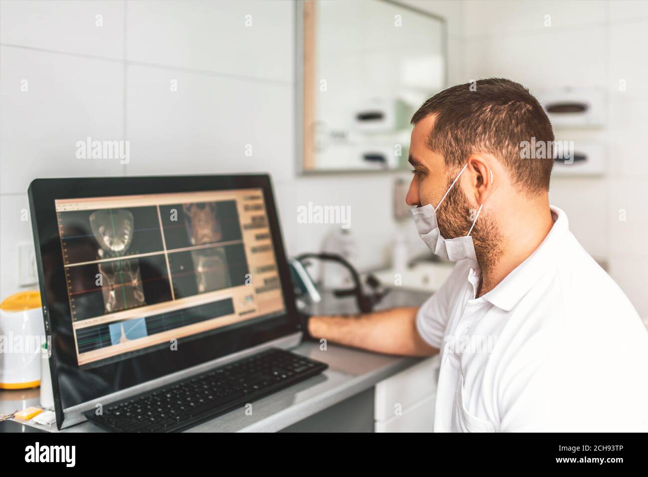 Dentist making examination of the x-ray and choosing treatment in the clinic Stock Photo