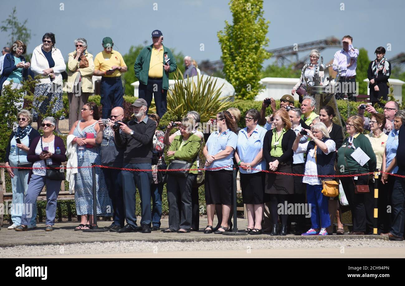 Relatives and members of the public watch as Queen Elizabeth II attends a service at the National Memorial Arboretum in Alrewas, Staffordshire, in tribute to soldiers from the Duke of Lancaster's Regiment killed while serving in Afghanistan. Stock Photo