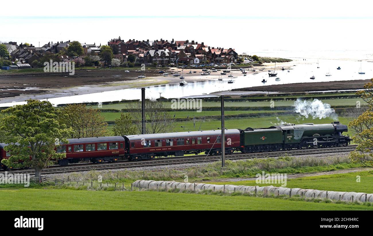 The Flying Scotsman returns from its first visit to Scotland as it passes Alnmouth in Northumberland. Stock Photo