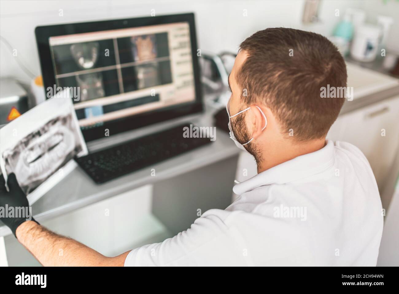 Dentist making examination of the x-ray and choosing treatment in the clinic Stock Photo