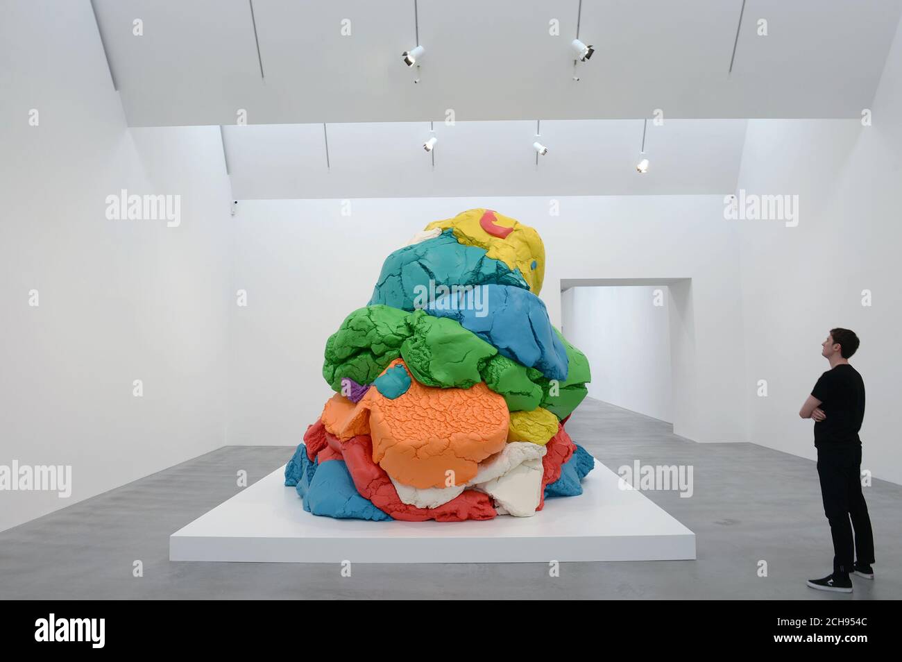 A man views Jeff Koons' sculpture PlayDoh 19942014 during the opening