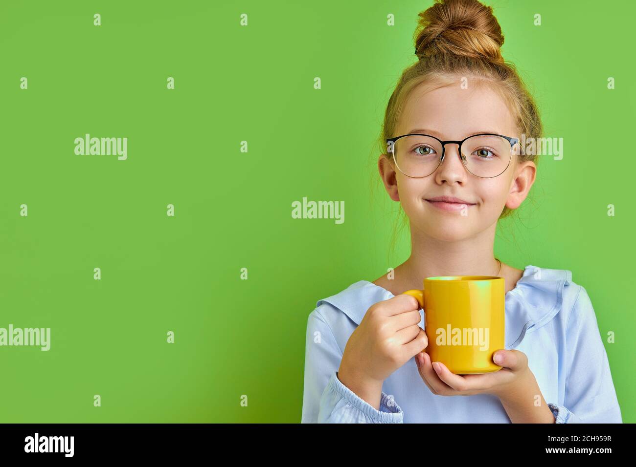 beautiful caucasian child girl drinking hot tea or coffee in the