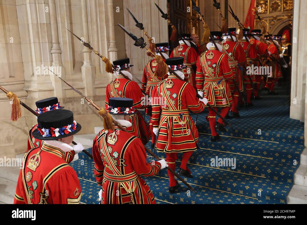 Yeoman of the Guard walk in through the Sovereigns entrance at Houses of Parliament ahead of the State Opening of Parliament at the Palace of Westminster in London. Stock Photo