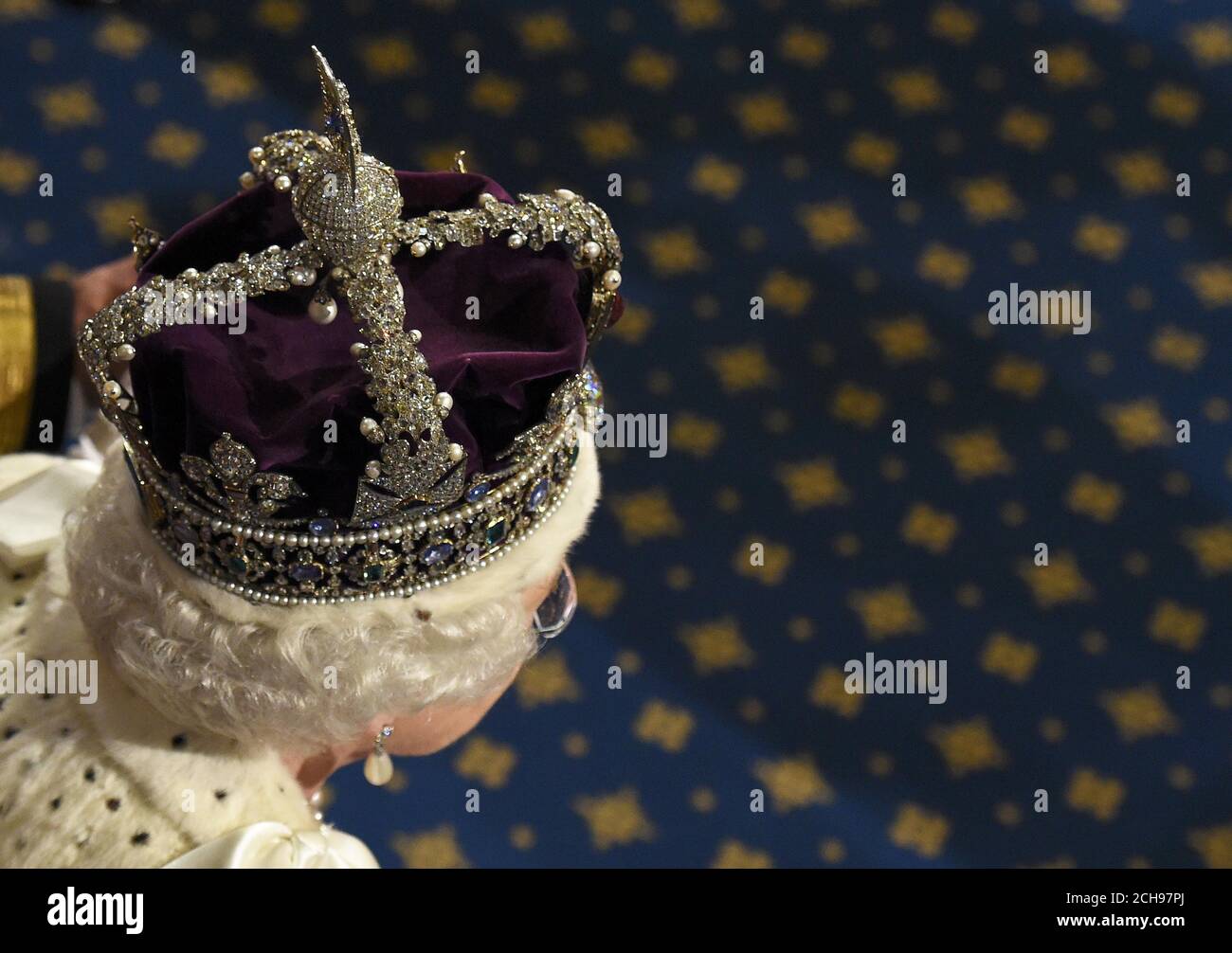 Queen Elizabeth II proceeds through the Royal Gallery ahead of the State Opening of Parliament, in the House of Lords at the Palace of Westminster in London. Stock Photo