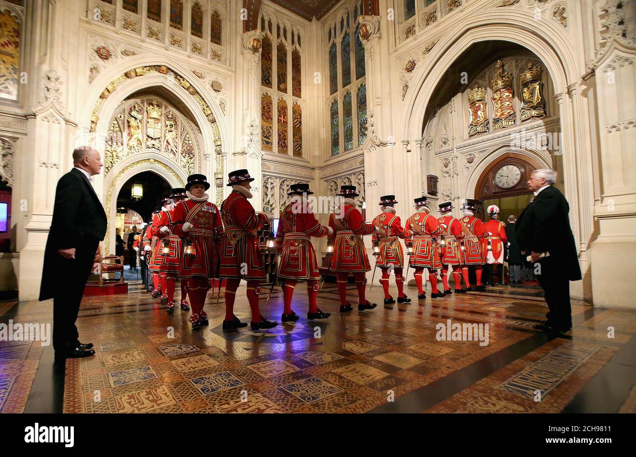The Yeoman of the Guard walk through the Peer's Lobby after carrying out the Ceremonial Search, ahead of the State Opening of Parliament, in the House of Lords at the Palace of Westminster in London. Stock Photo
