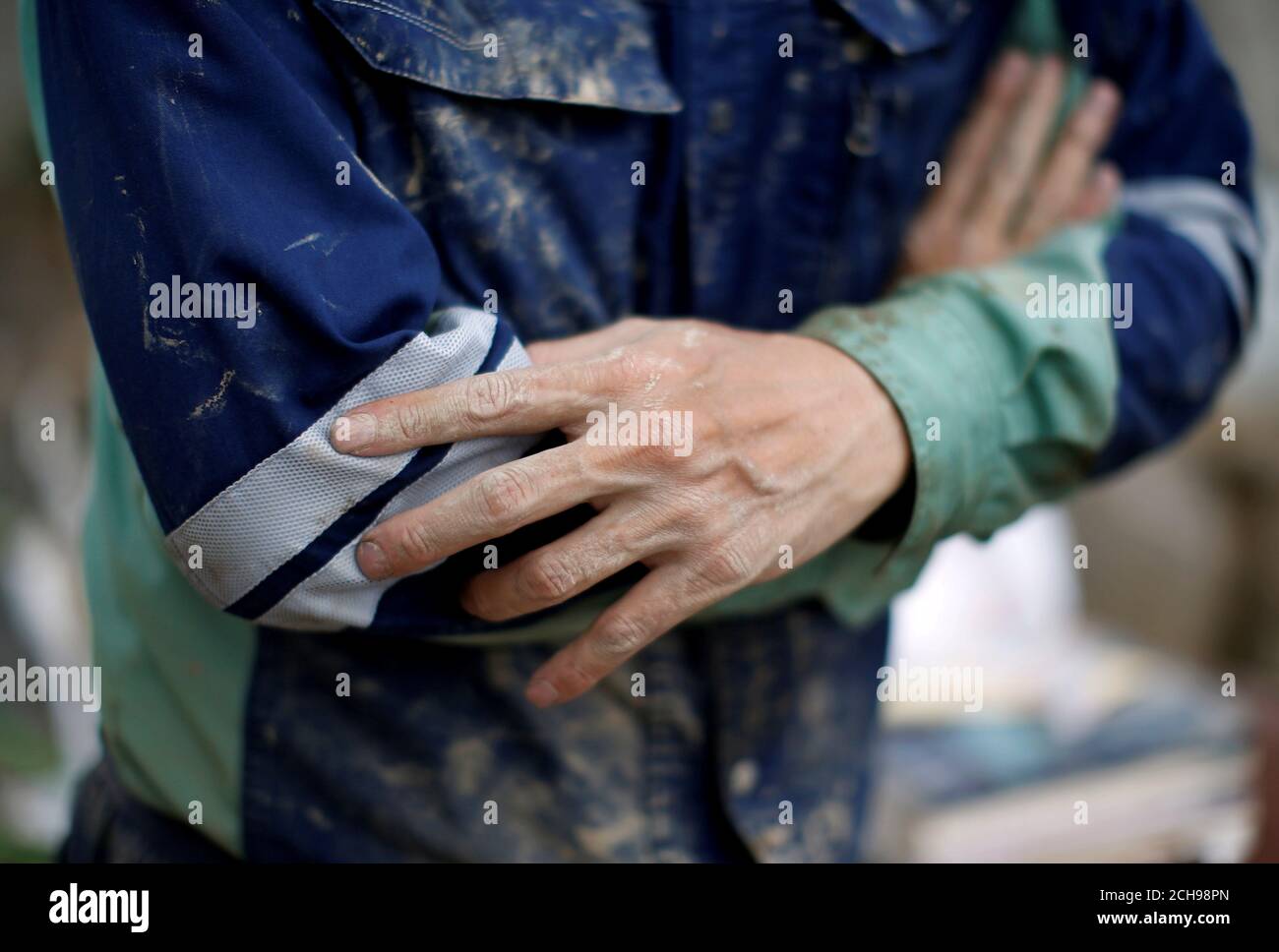 Muddy Hands Of 51 Year Old Kairyu Takahashi An Okayama Prefectural Assemblyman Are Seen As He Tries To Remove Mud And Debris From His House In A Flood Affected Area In Mabi Town In