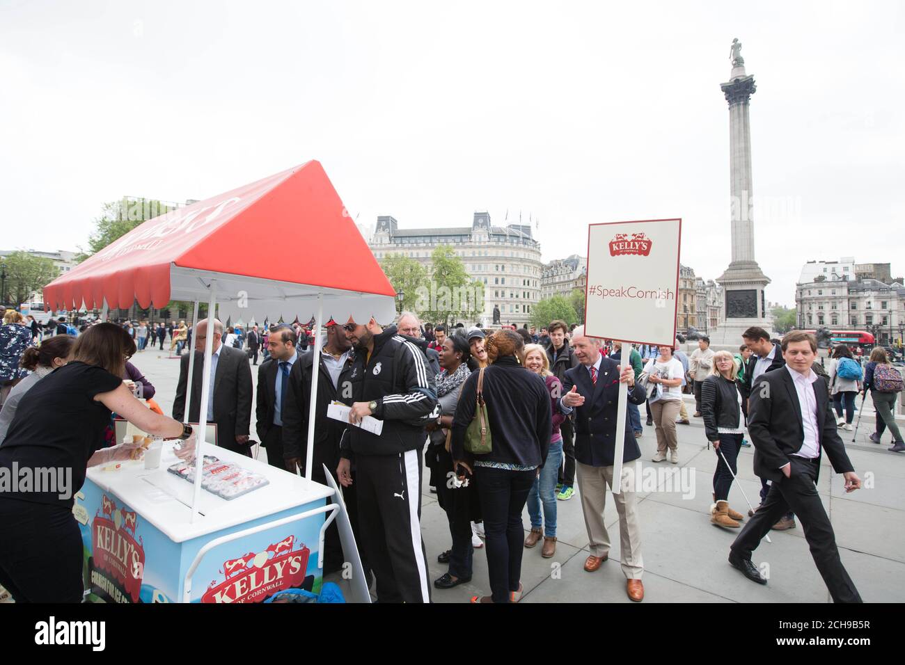 Members of the public queue for Kellys of Cornwall ice cream in Trafalgar Square in London, as protestors raise awareness of the Cornish language following the recent Government funding cuts. Stock Photo