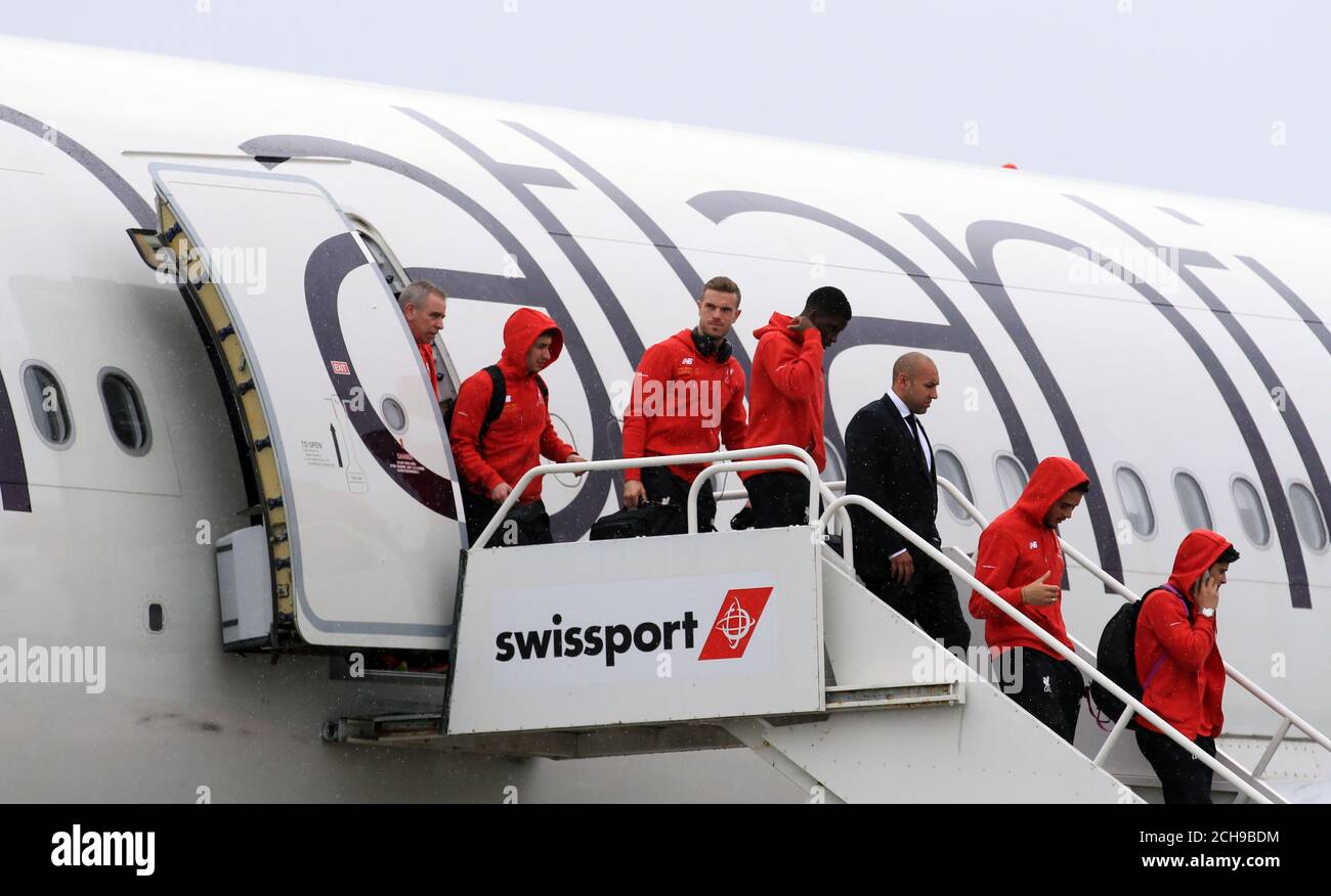 Liverpool's Jordan Henderson (centre) and team-mates arrive at Liverpool John Lennon Airport. Stock Photo