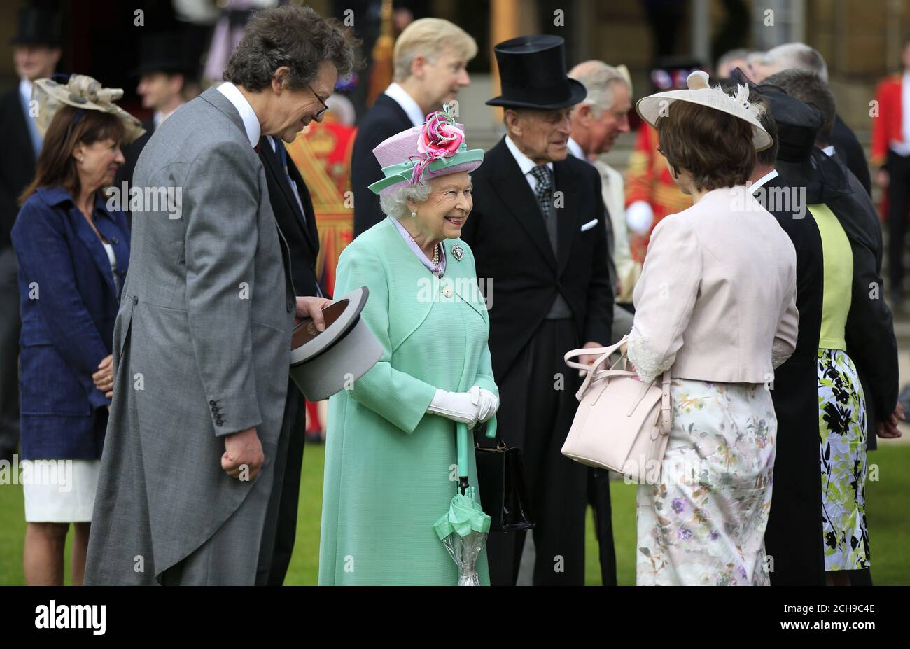 Queen Elizabeth II meets guests during a garden party at Buckingham Palace in London. Stock Photo